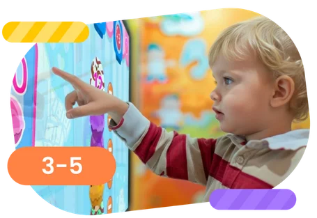 Child interacting with an educational touchscreen game for early learning (ages 3–5).