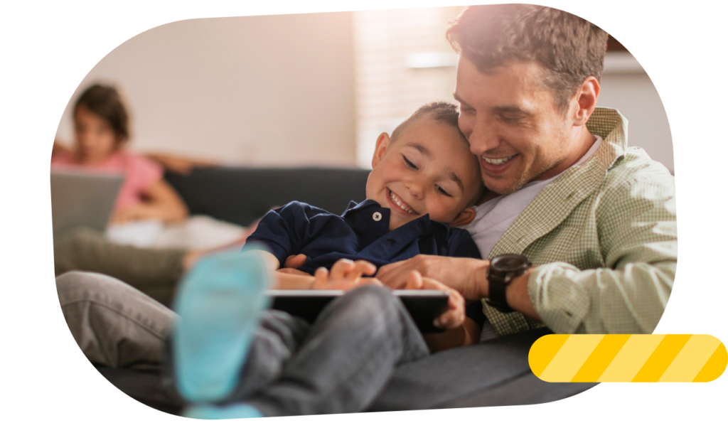 Father and child playing together with a tablet.